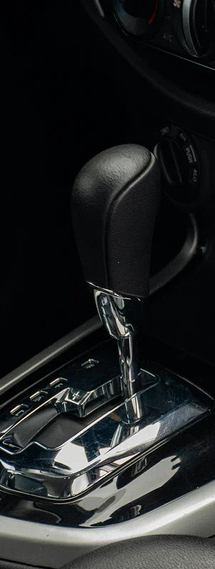 Black leather automatic gear shifter with chrome trim in European car interior